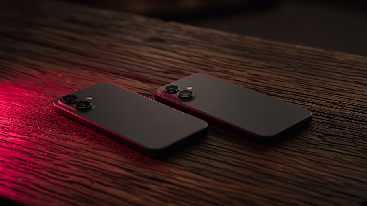 Two phones on a dark table.